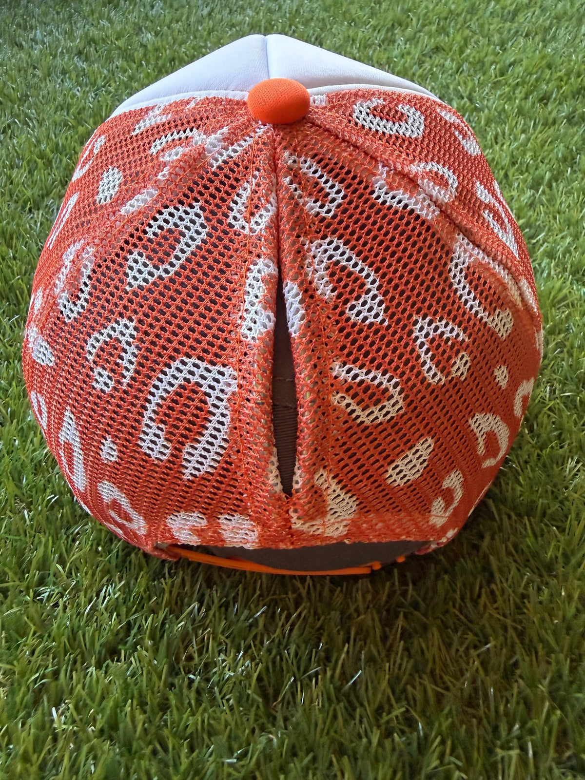 Spooky on a custom trucker hat with a magna pony and orange and white leopard detailed mesh