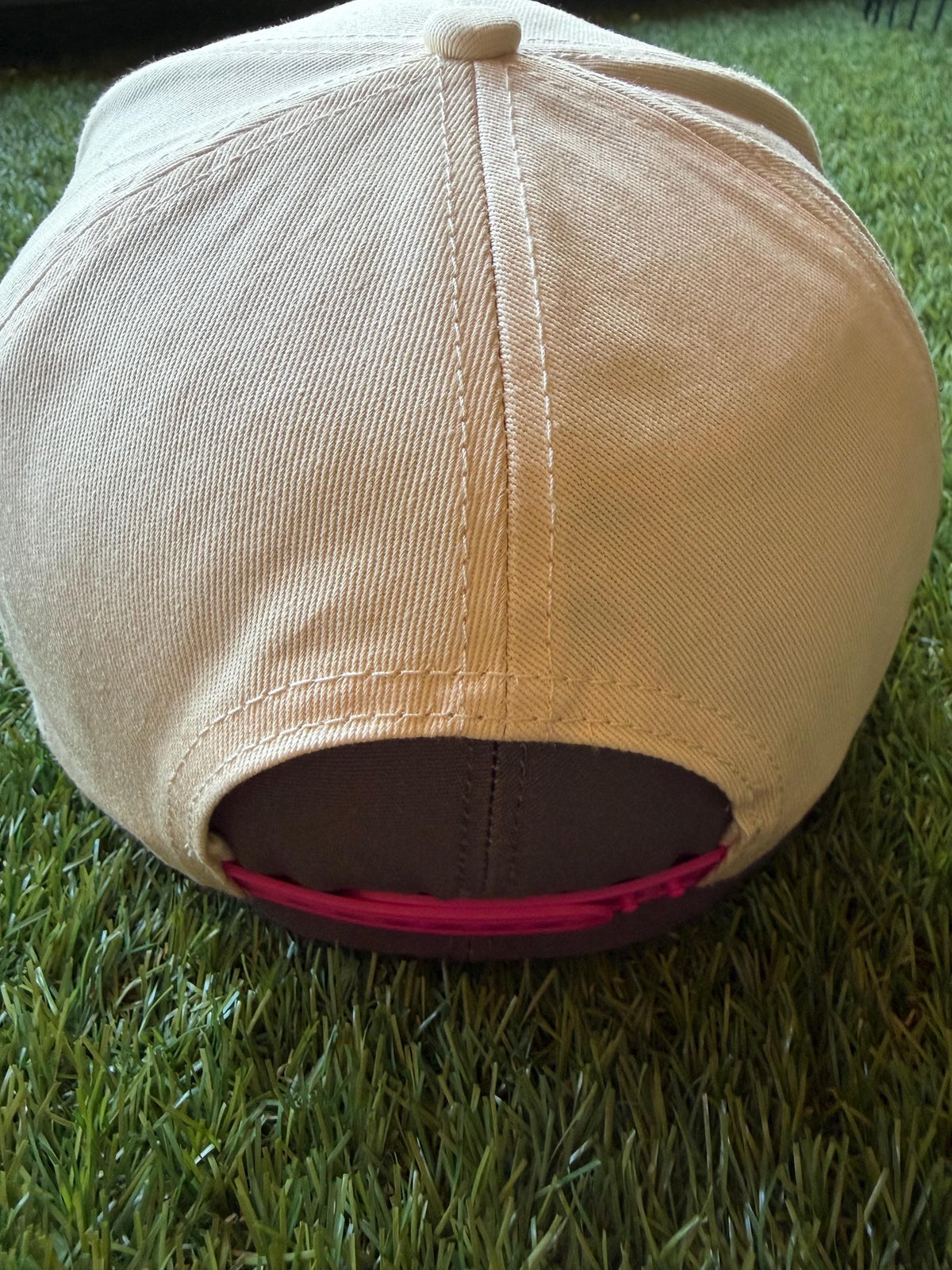 Ol Red’s Itching to Have A Little Fun on a custom canvas trucker with a camouflage brim and hot pink rope detailing