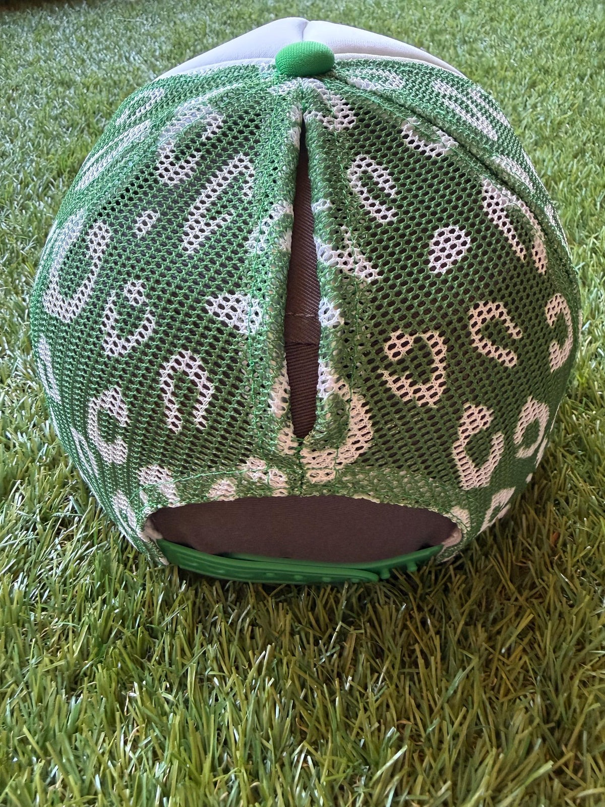 Gameday with a green star on a custom mesh magna pony trucker hat with a football hat chain