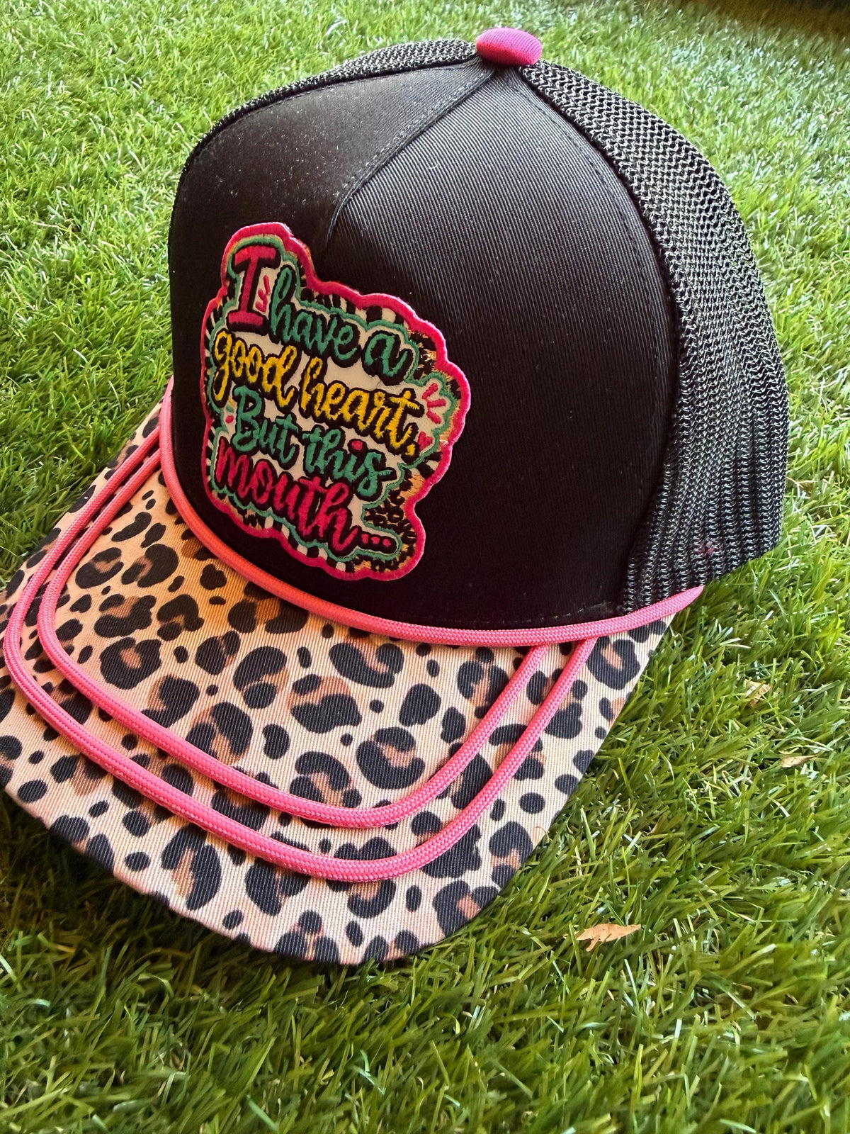 I Have A Good Heart But This Mouth embroidered patch on a custom canvas mesh trucker hat combo with a leopard brim and hot pink detailing