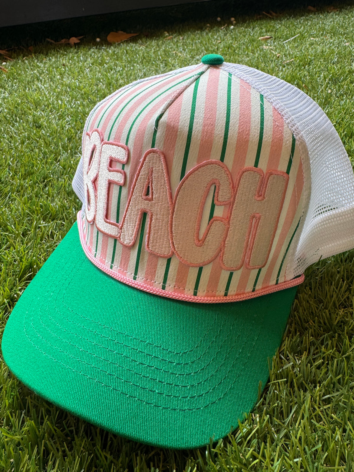 BEACH embroidered patch on green and pink strip hat