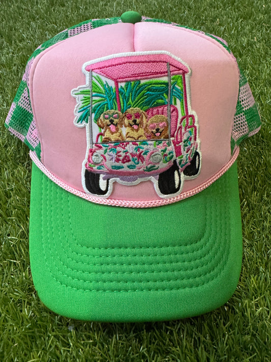 Dogs on a golf cart on pink/green mesh trucker hat