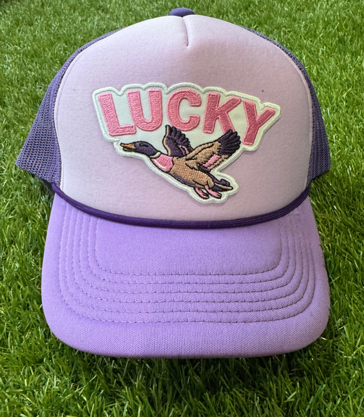 Lucky Duck on tricolor purple mesh trucker hat with magna pony