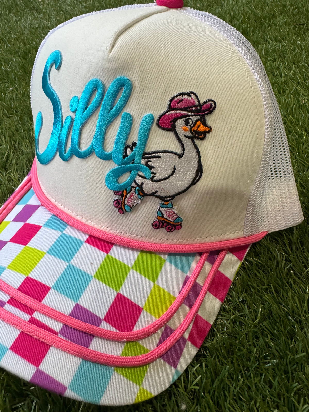 Silly Goose on skates on multicolored checkered brim canvas trucker hat