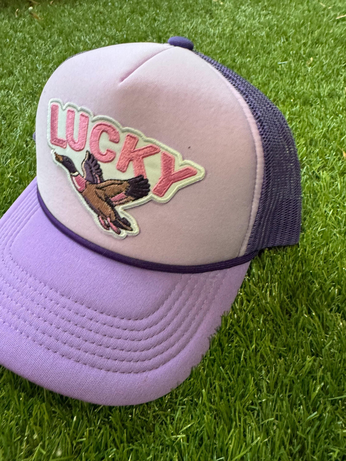 Lucky Duck on purple tri color trucker hat with magna pony