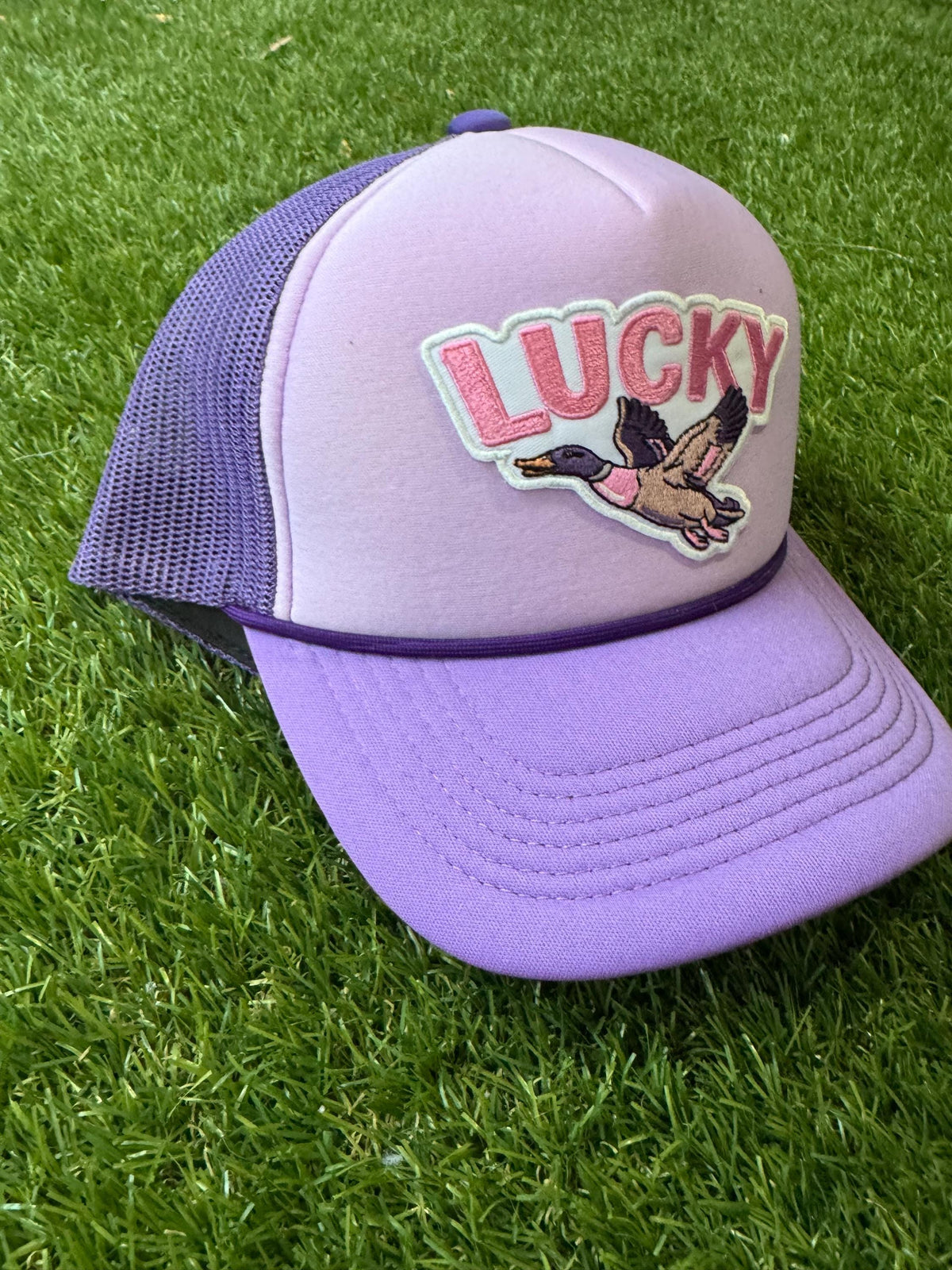 Lucky Duck on purple tri color trucker hat with magna pony