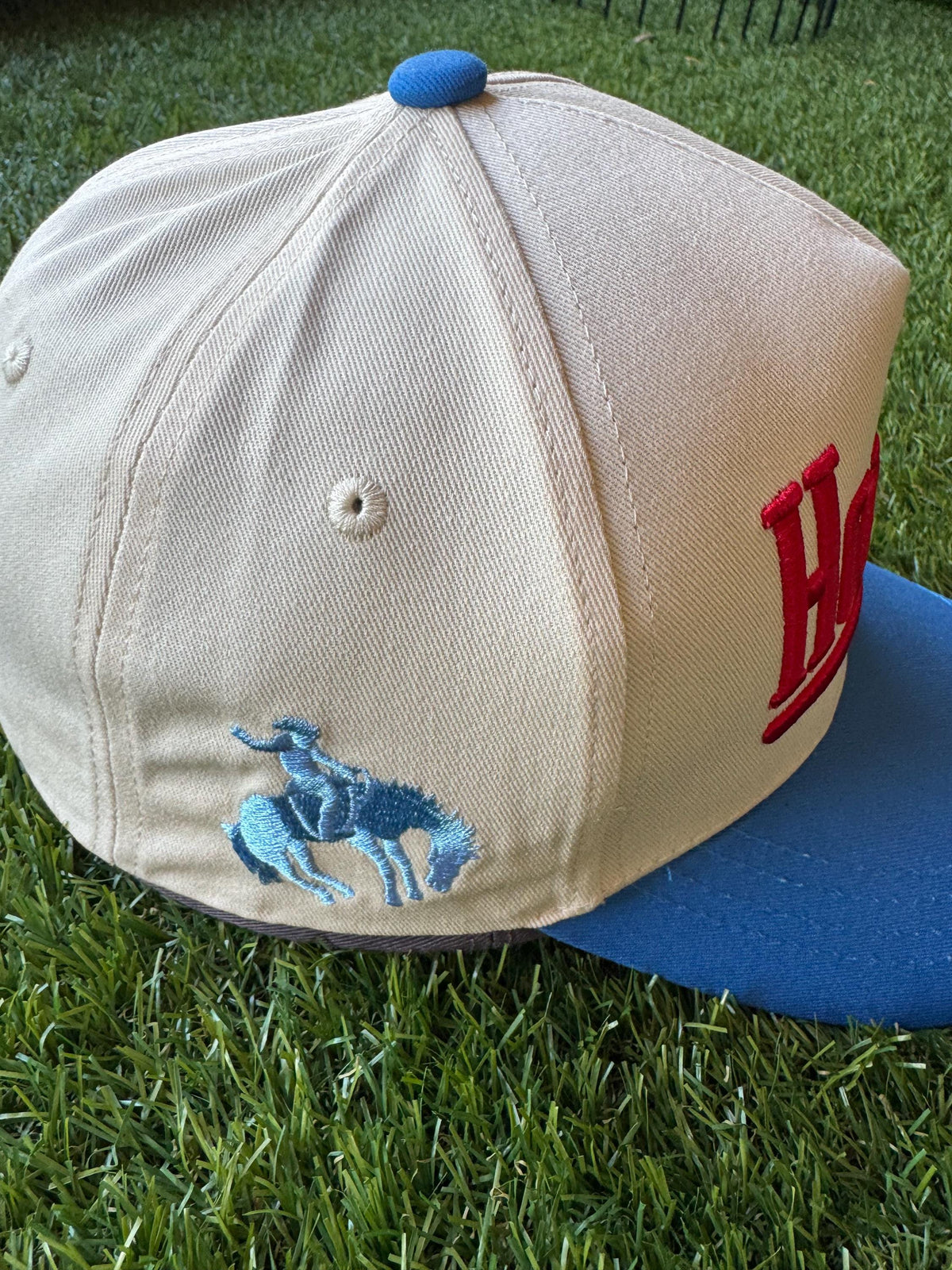 HOWDY embroidered canvas trucker hat with cowboy embroidered detail on side
