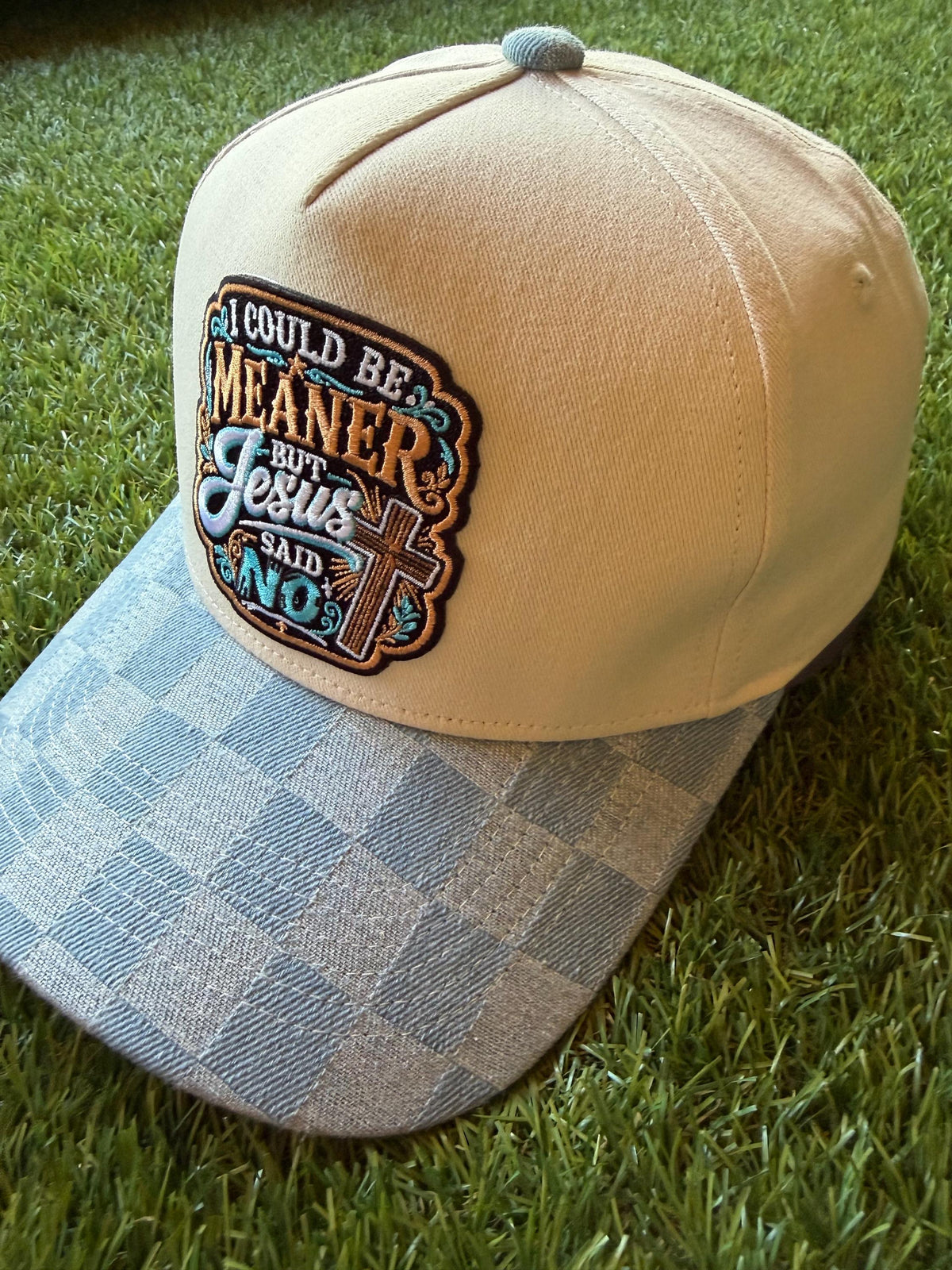I Could Be Meaner but Jesus Said No on a custom canvas trucker hat with a checkered denim brim