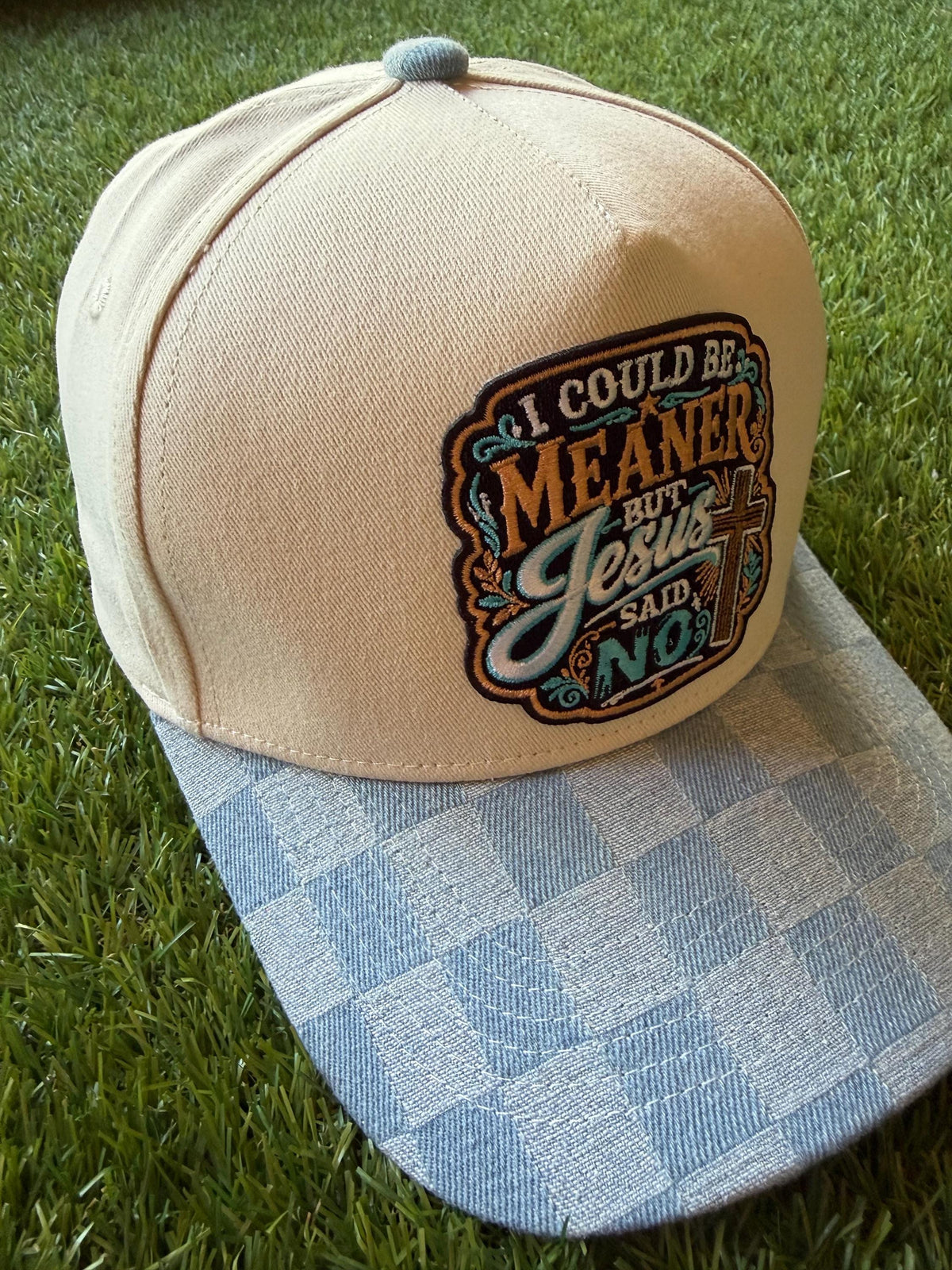 I Could Be Meaner but Jesus Said No on a custom canvas trucker hat with a checkered denim brim