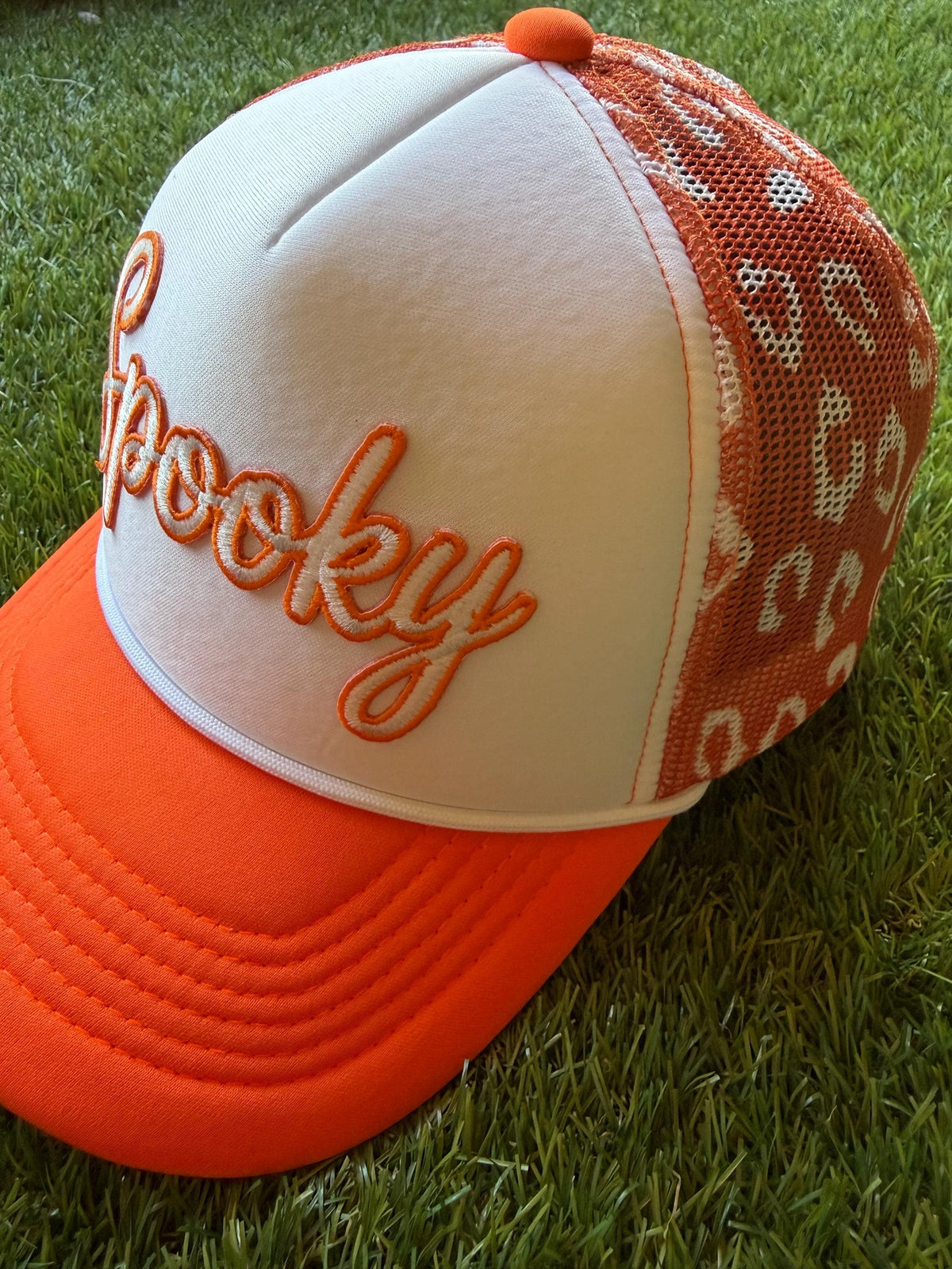 Spooky on a custom trucker hat with a magna pony and orange and white leopard detailed mesh