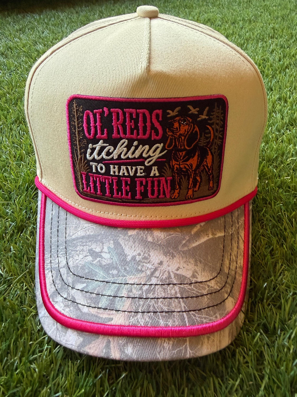 Ol Red’s Itching to Have A Little Fun on a custom canvas trucker with a camouflage brim and hot pink rope detailing