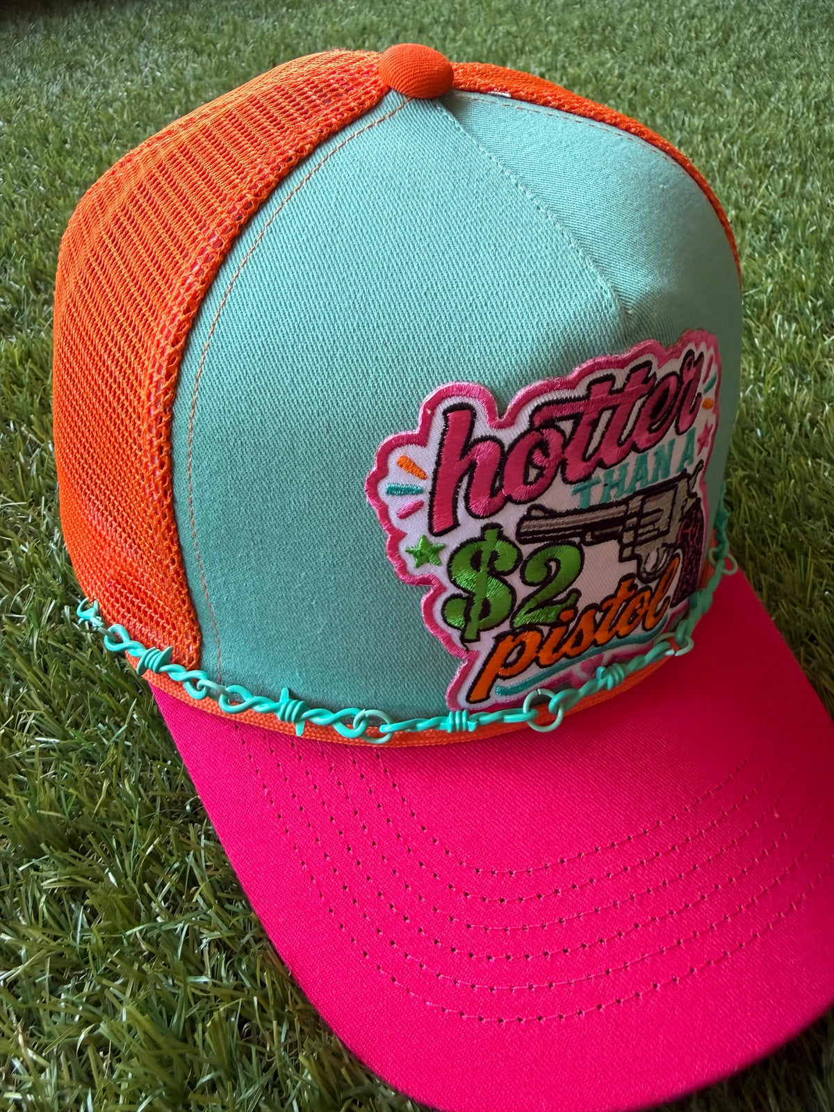 Hotter Than A 2 Dollar Pistel on a tri color canvas/mesh custom trucker hat with a hat chain