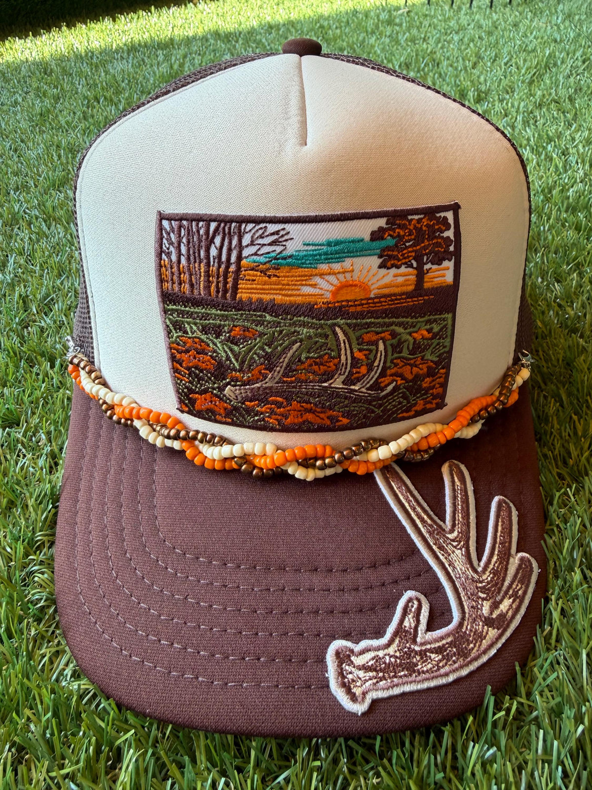 Deer Antler with Sunset embroidered patches on custom trucker hat with coordinating hat chain