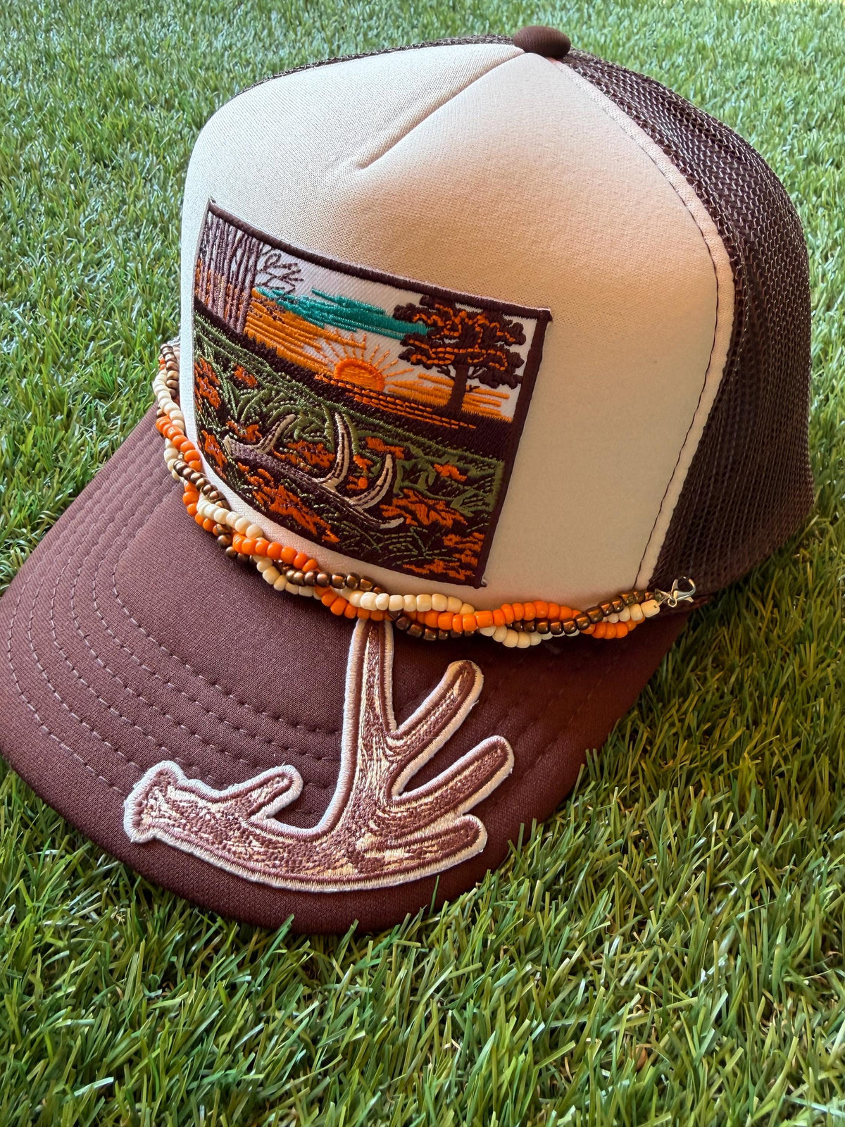 Deer Antler with Sunset embroidered patches on custom trucker hat with coordinating hat chain