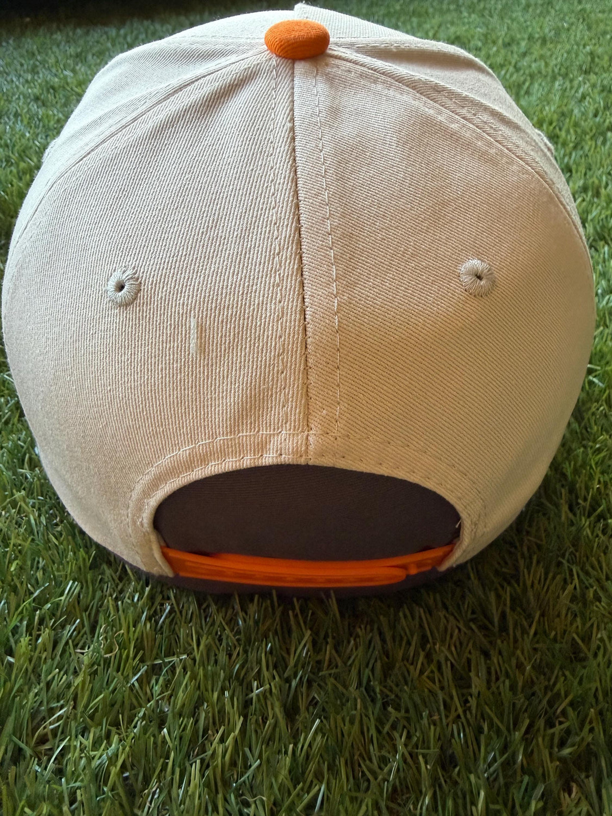 Spooky embroidered patch with ghost blowing a bubble on custom canvas trucker hat with orange brim