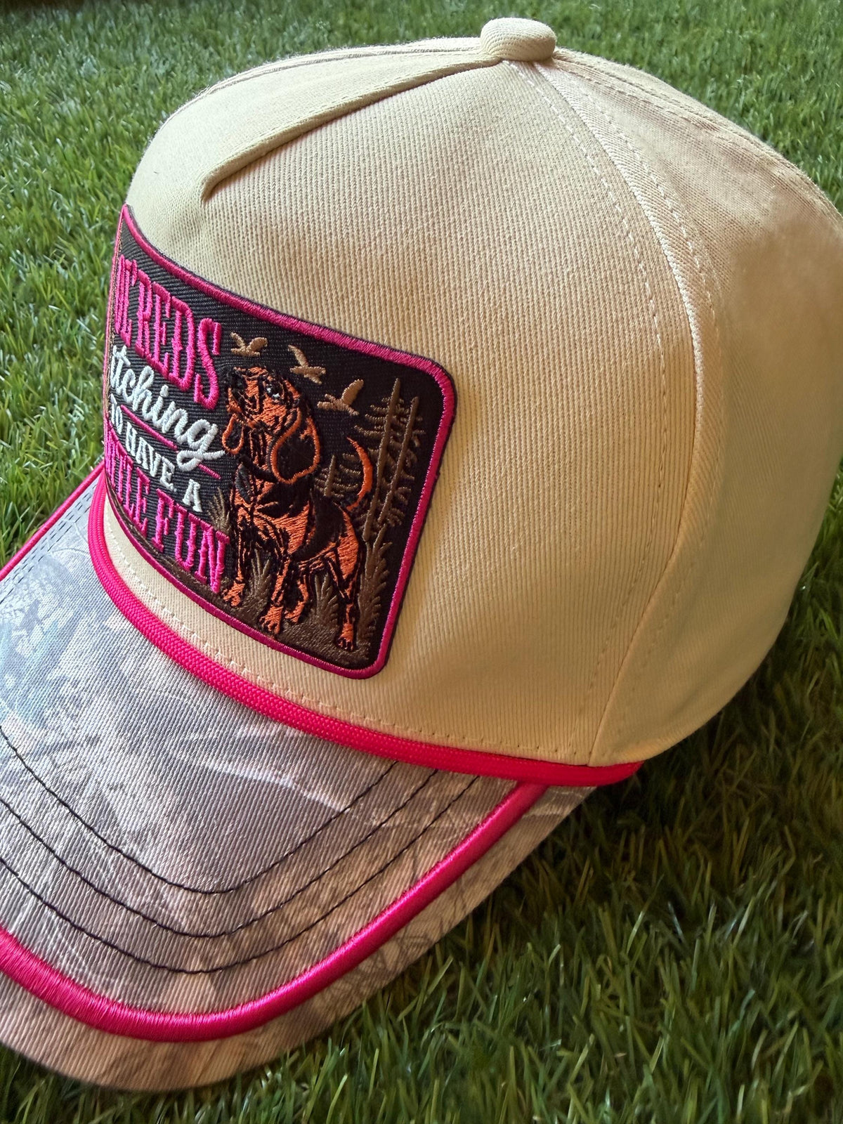 Ol Red’s Itching to Have A Little Fun on a custom canvas trucker with a camouflage brim and hot pink rope detailing