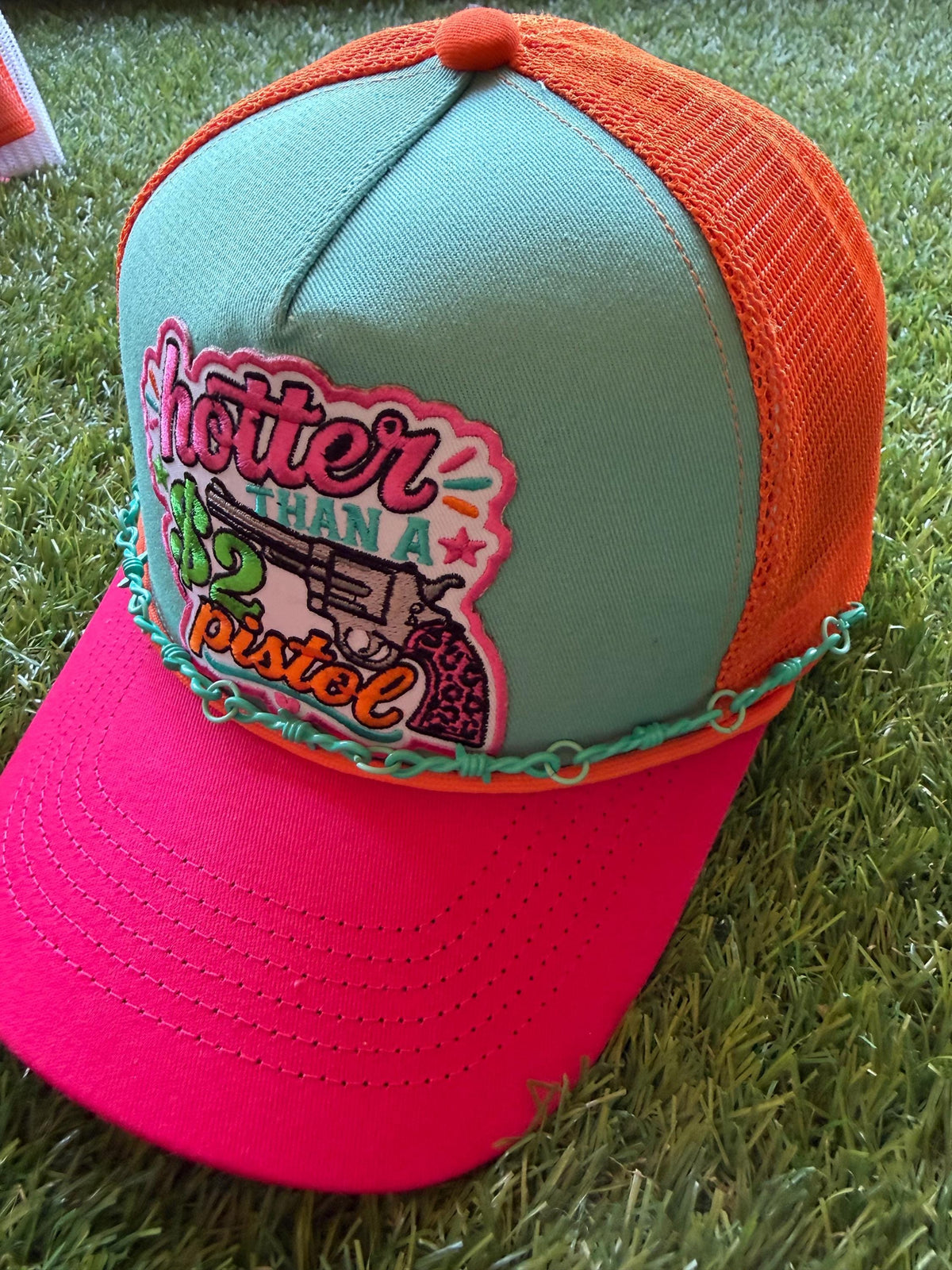 Hotter Than A 2 Dollar Pistel on a tri color canvas/mesh custom trucker hat with a hat chain