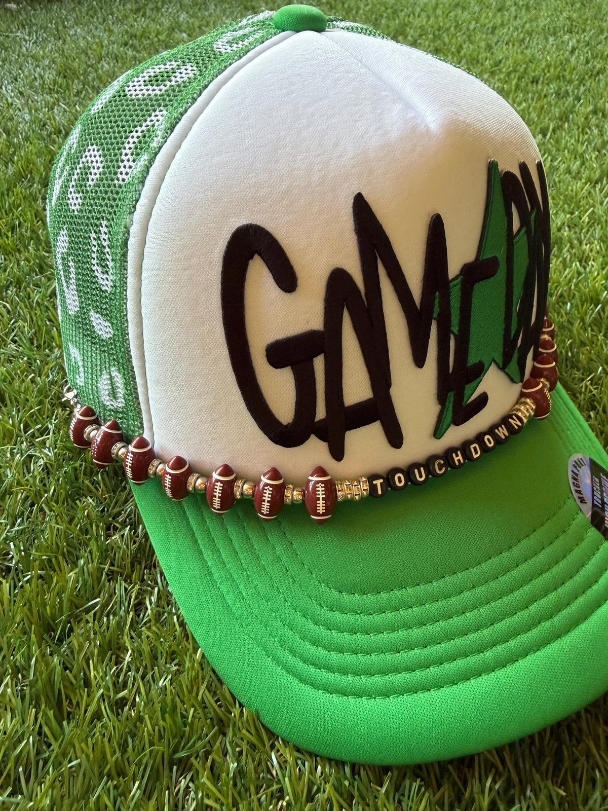 Gameday with a green star on a custom mesh magna pony trucker hat with a football hat chain