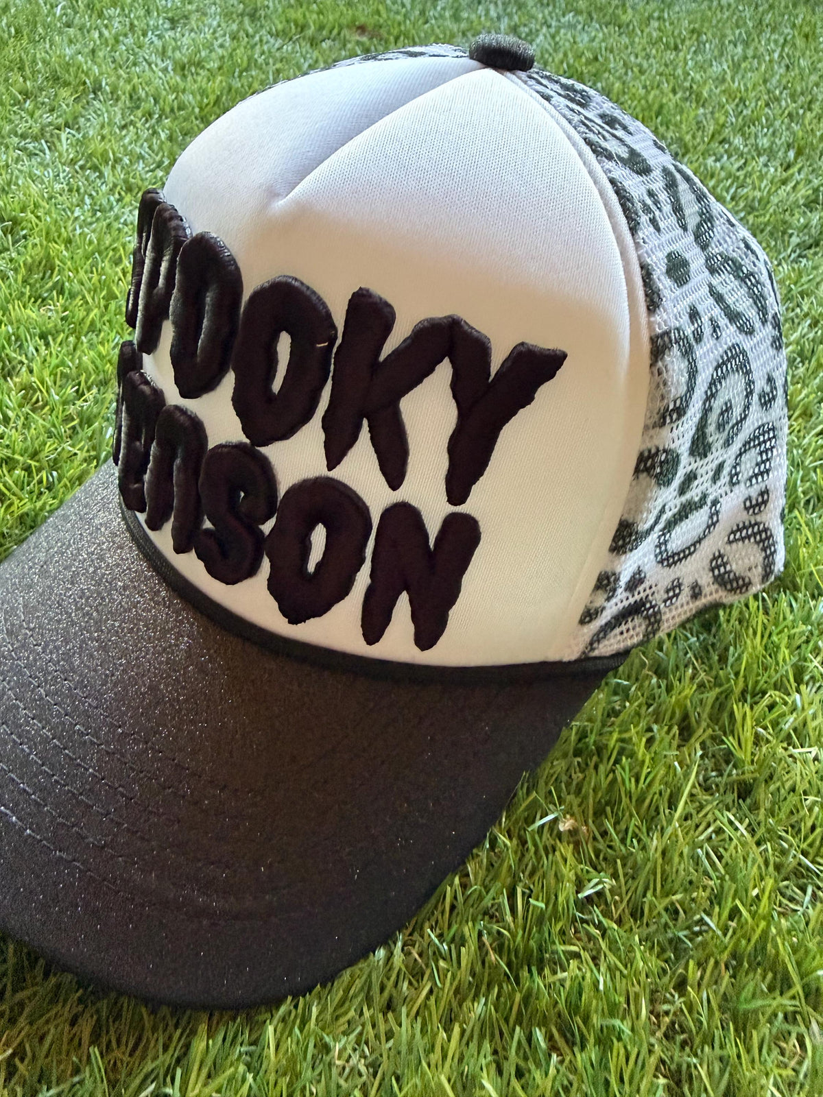 SPOOKY SEASON embroidered letter patch on custom trucker hat with glitter brim and leopard mesh