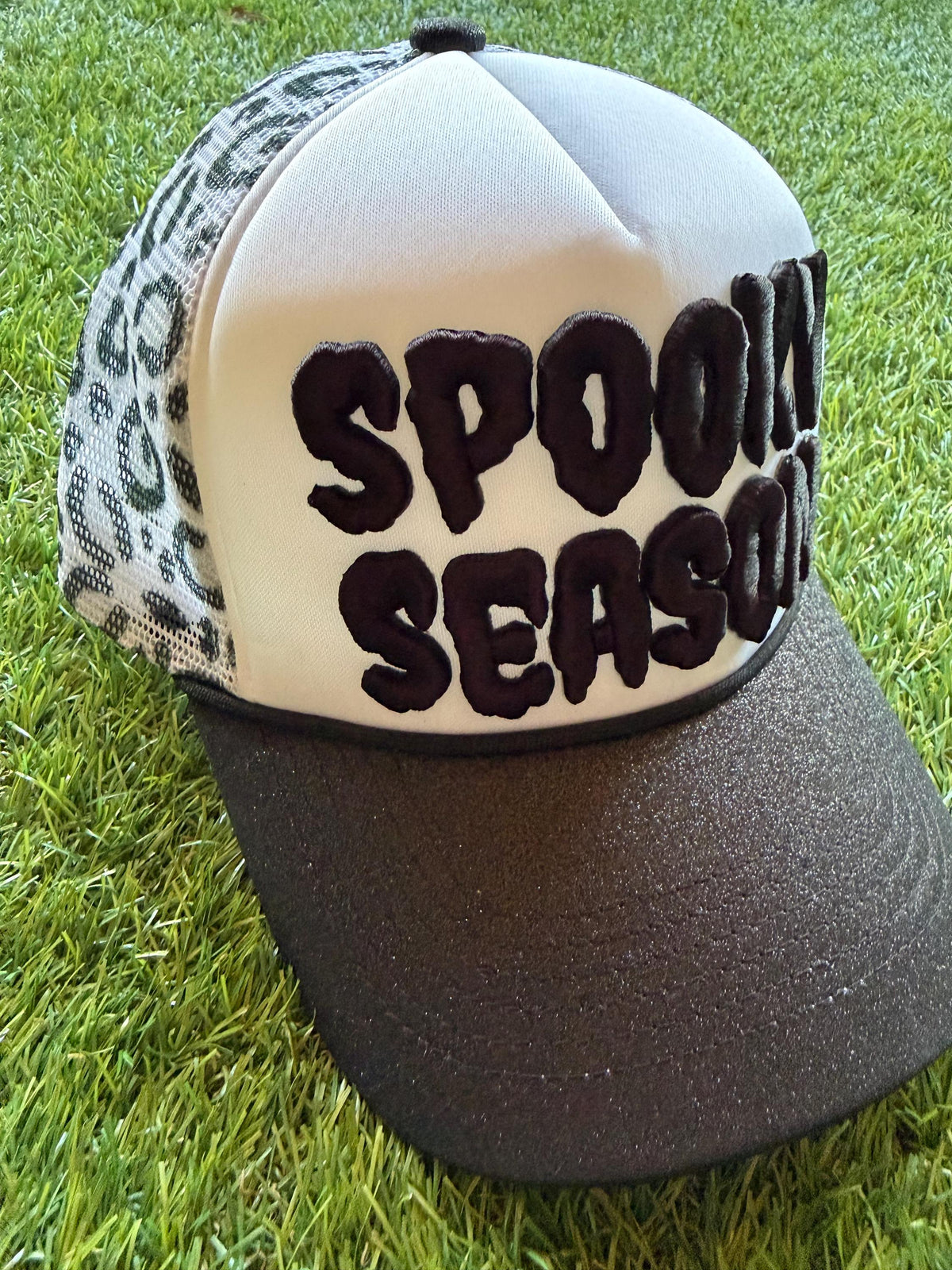 SPOOKY SEASON embroidered letter patch on custom trucker hat with glitter brim and leopard mesh