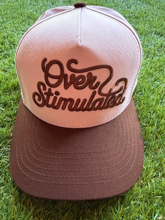 Over Stimulated embroidered word patch on a custom canvas trucker hat