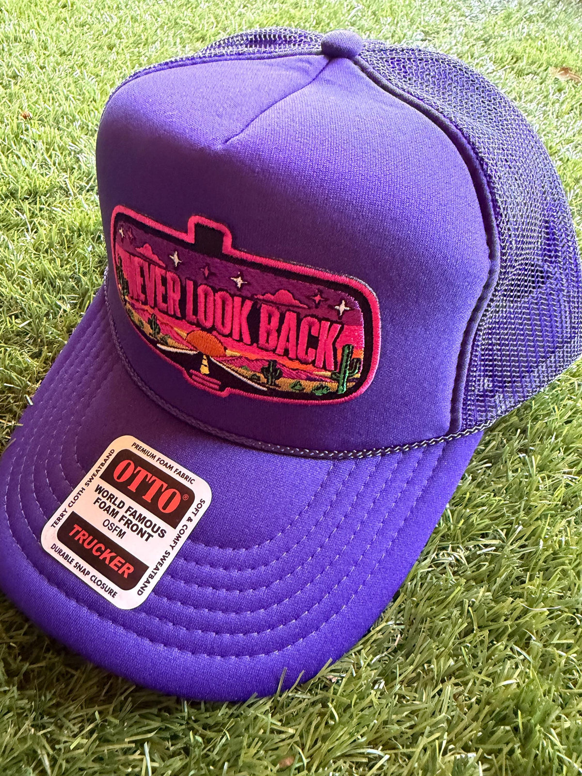 Never Look Back embroidered patch on a custom mesh trucker hat