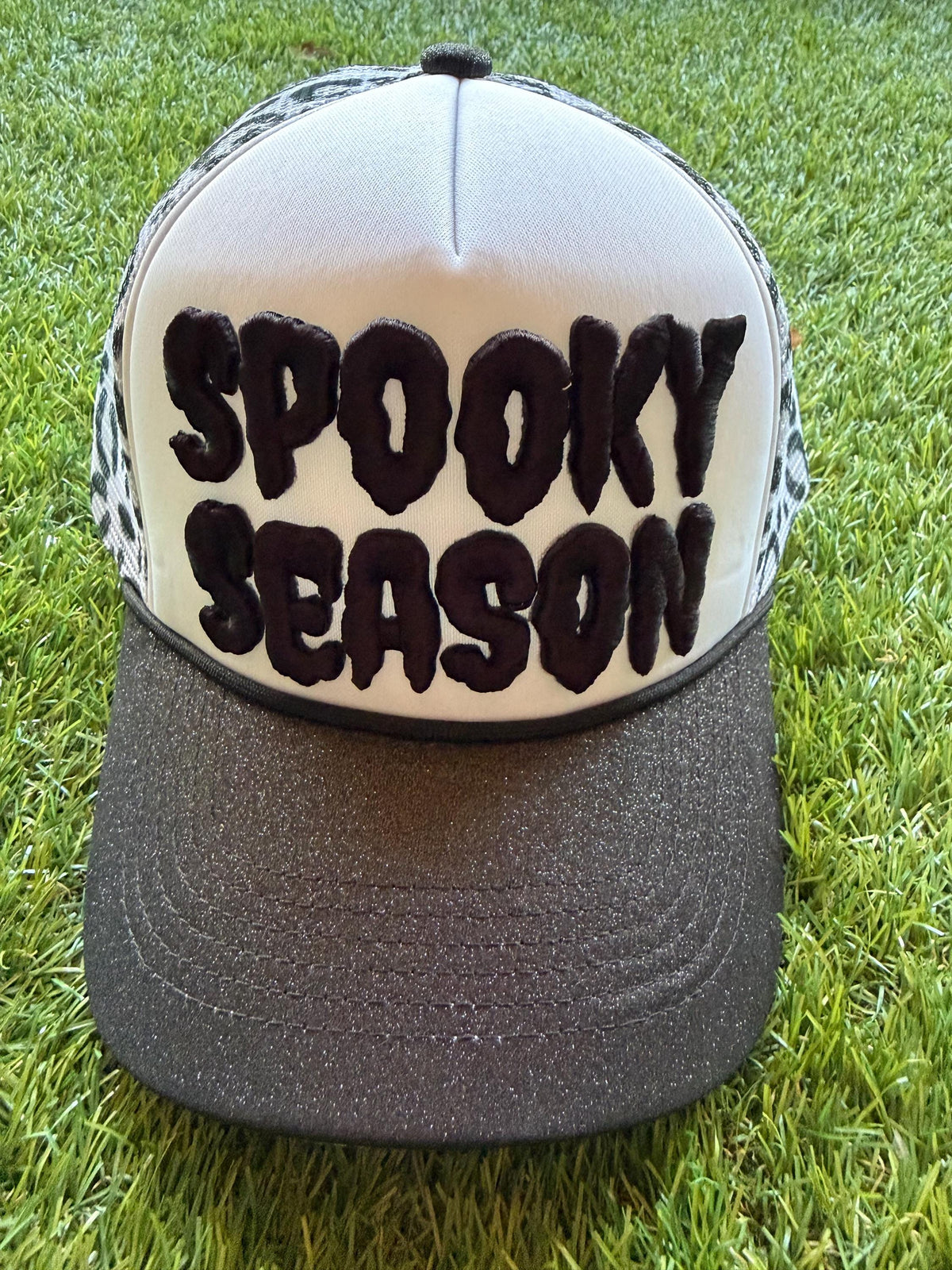 SPOOKY SEASON embroidered letter patch on custom trucker hat with glitter brim and leopard mesh