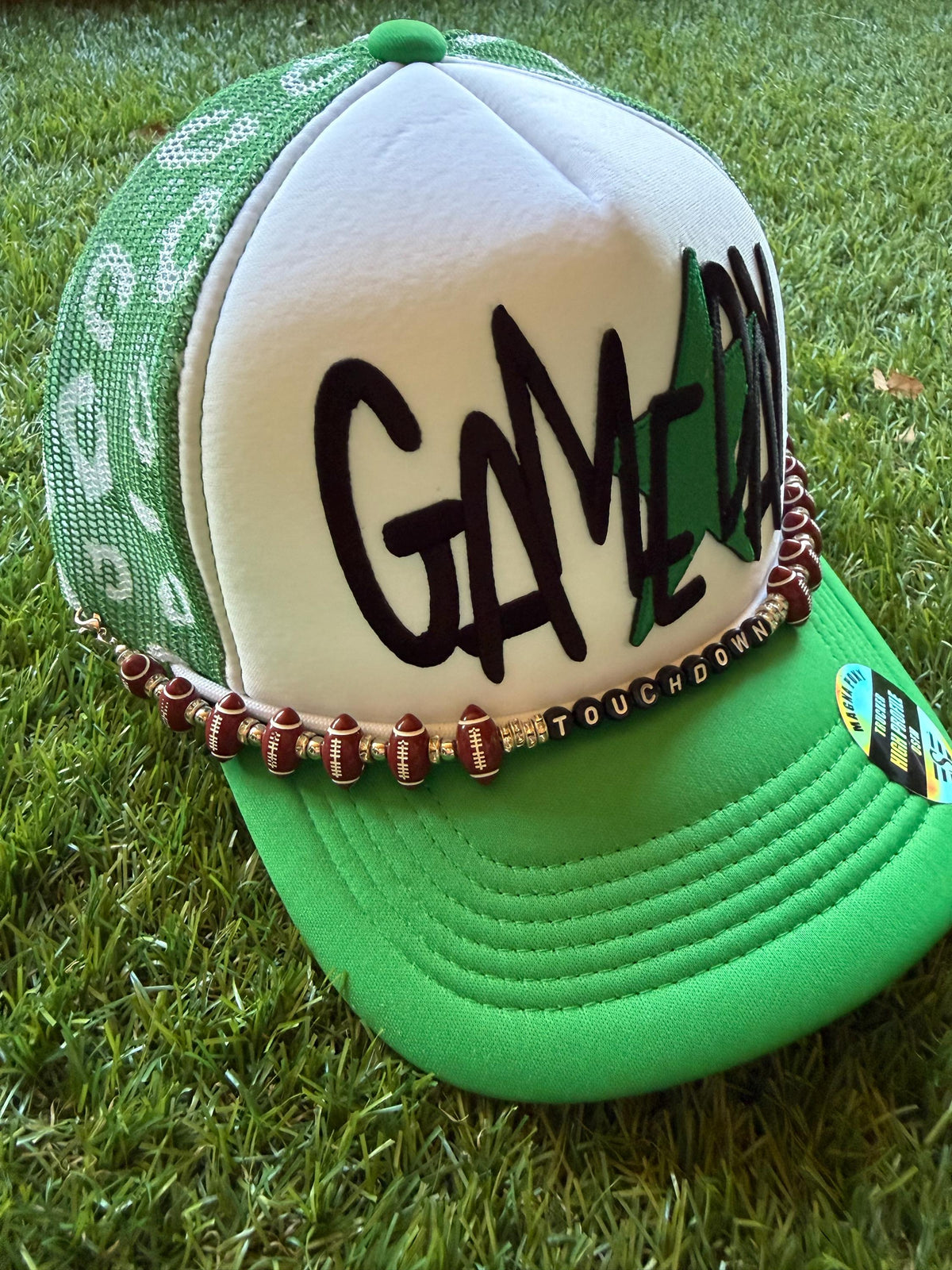 GAMEDAY with green star embroidered patch on custom mesh trucker hat with hat chain