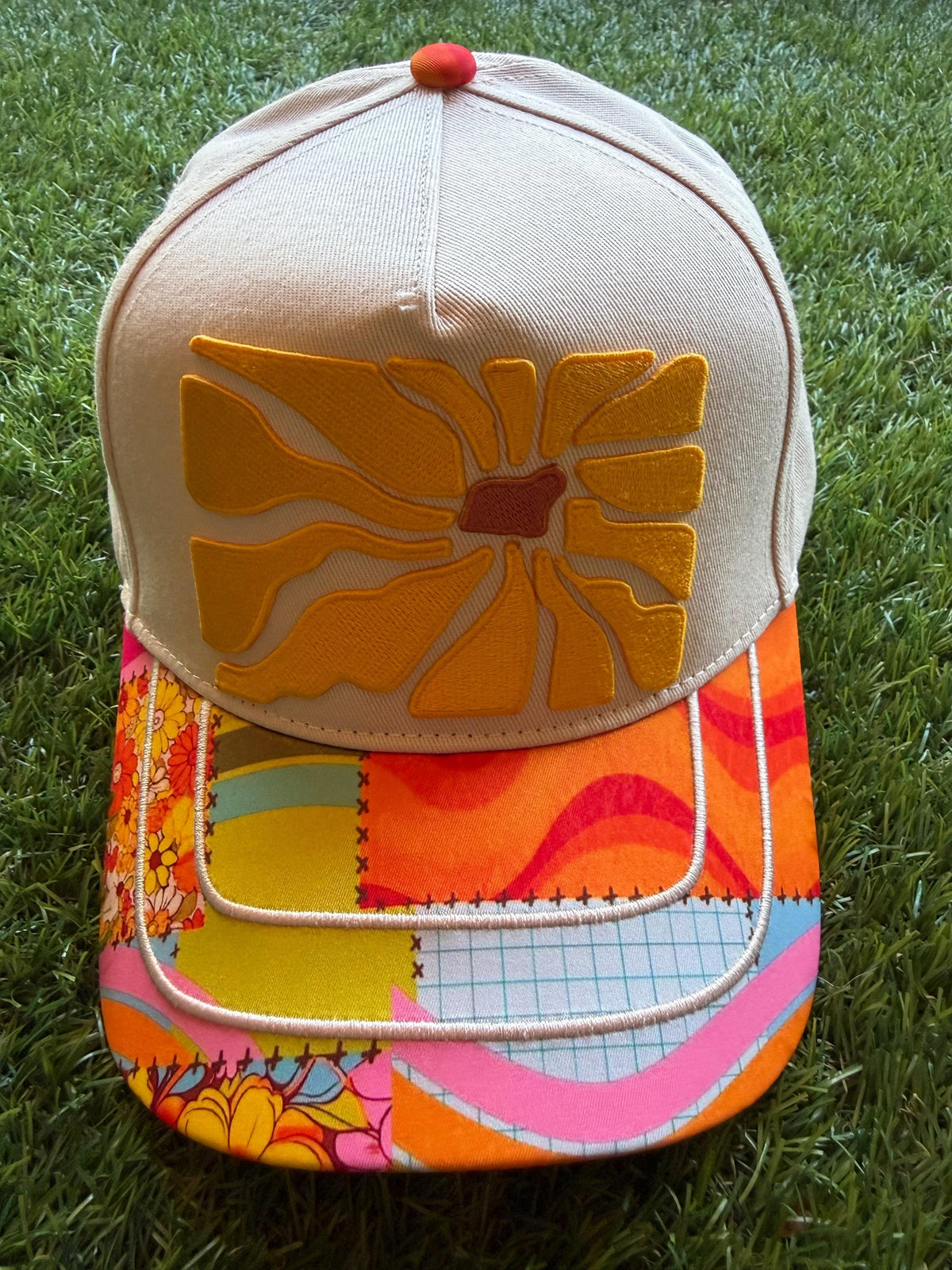 Floral embroidered patch on custom canvas trucker hat with boho style brim
