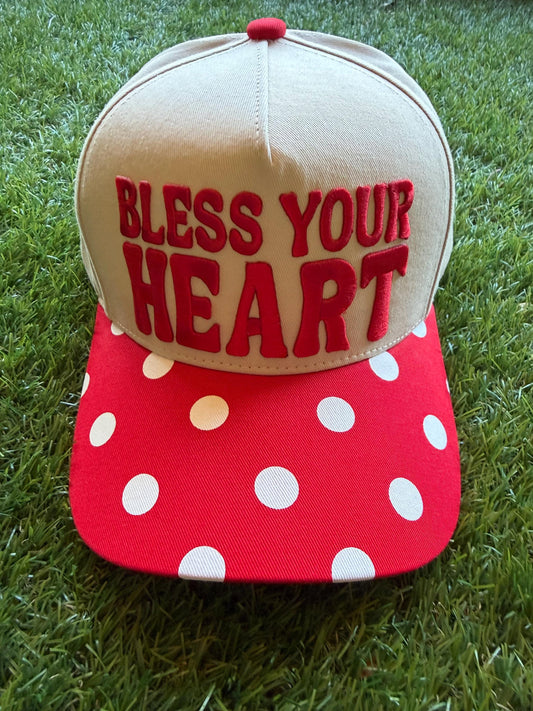 BLESS YOUR HEART embroidered word patch on a custom canvas trucker hat with red and white polka dot brim