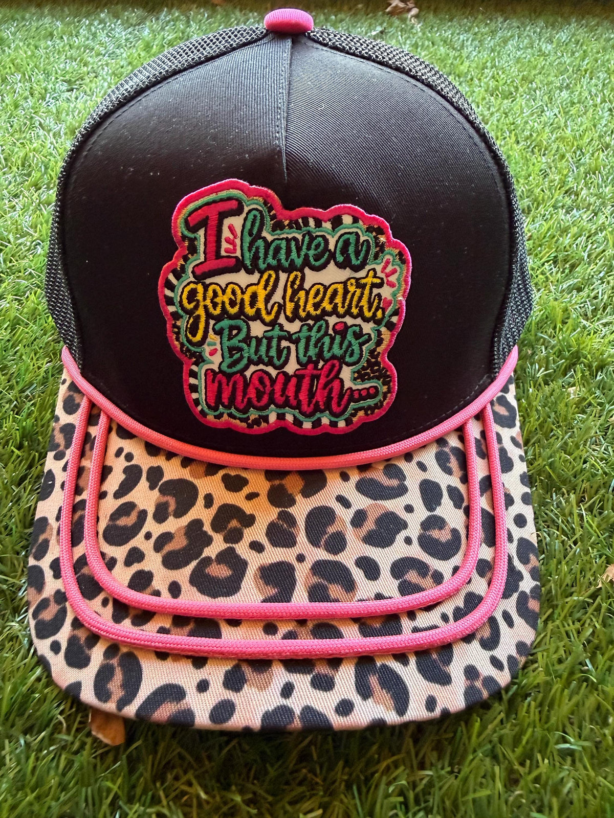 I Have A Good Heart But This Mouth embroidered patch on a custom canvas mesh trucker hat combo with a leopard brim and hot pink detailing